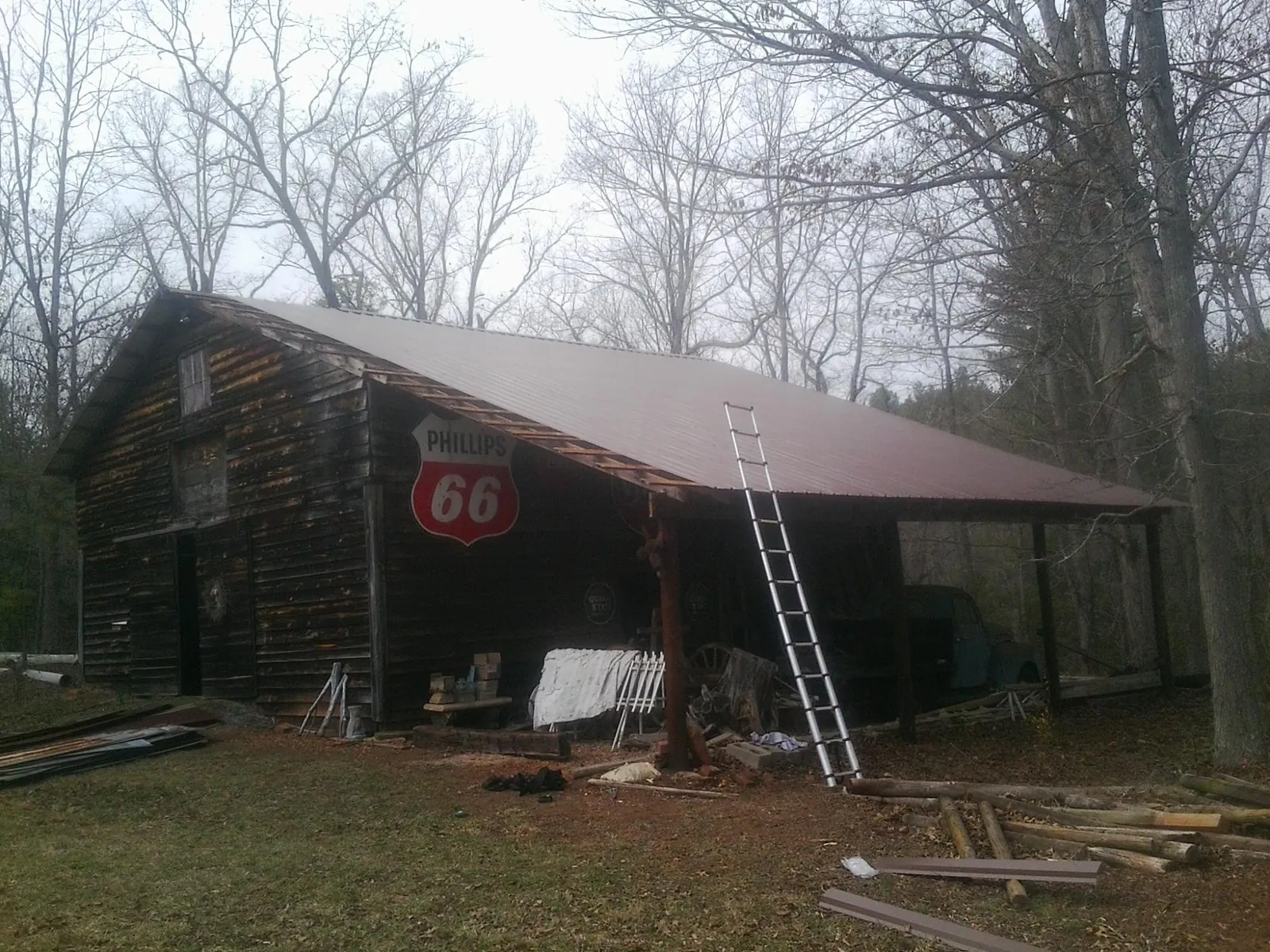 New metal roof on an open sided timber barn with a vintage sign in Springport